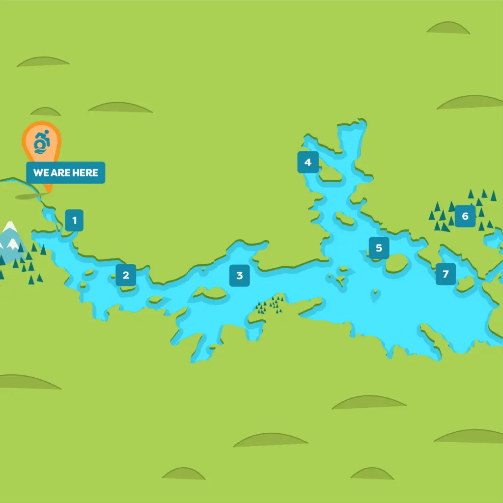 Illustrated map showing a large, branching blue lake with seven numbered locations marked. An orange pin at location 1 with a "We Are Here" label is on the lake’s western edge, near trees and a mountain.